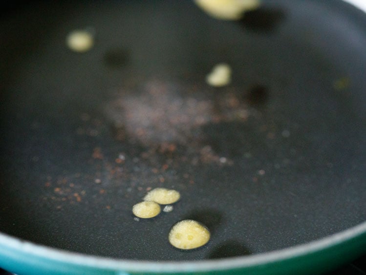 a pan having water, ghee and salt