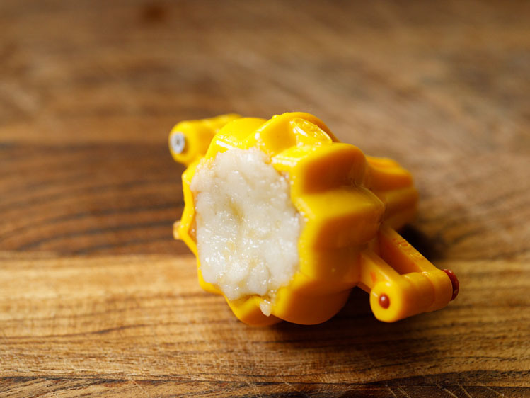 the bottom of the modak mould sealed and covered with a piece of rice flour dough