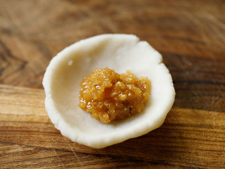 flattened balls shaped to a flat bowl with the stuffing in the center