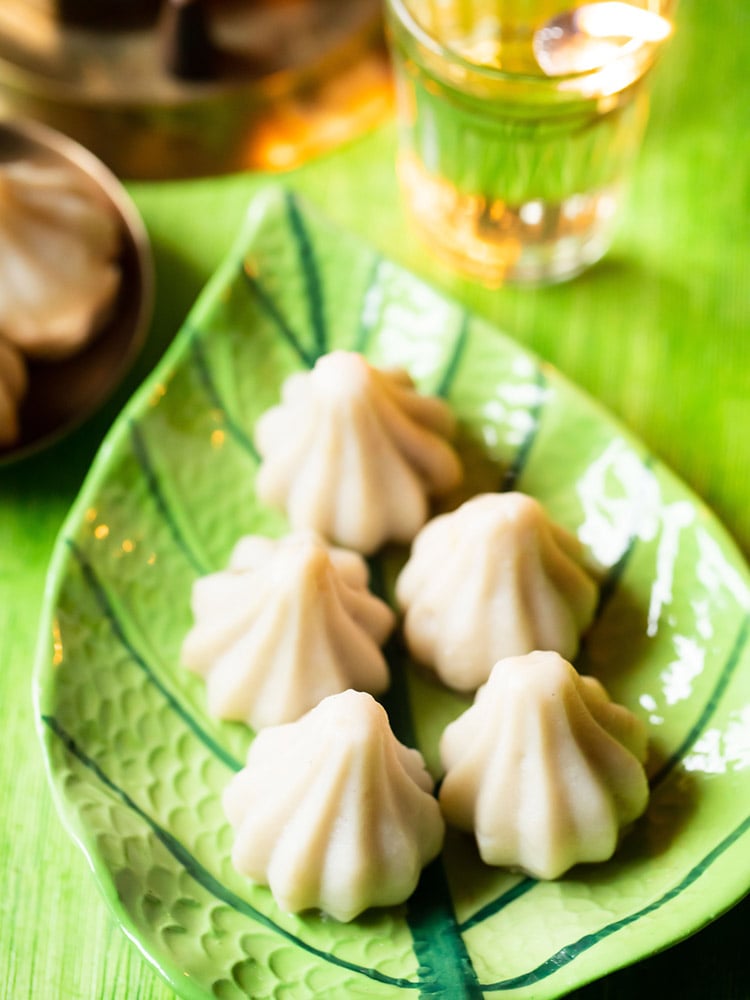 modak or modakam placed on a green leaf shaped platter