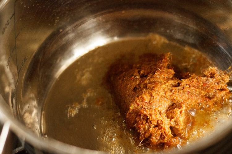 thai curry paste added to pan with oil