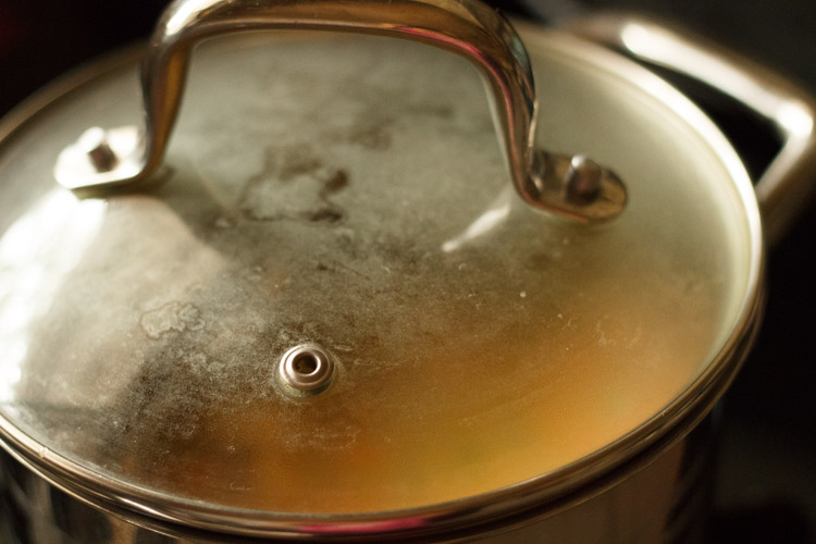 cooking veggies in Thai red curry with closed lid