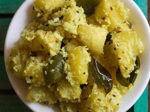 ash gourd thoran served in a white bowl.