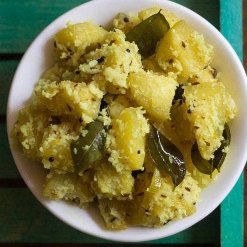 ash gourd thoran served in a white bowl.