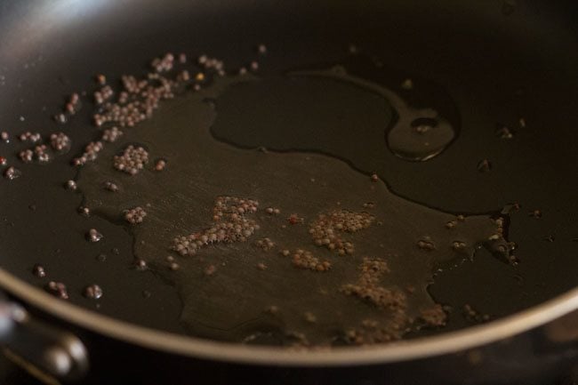 crackling mustard seeds in pan. 