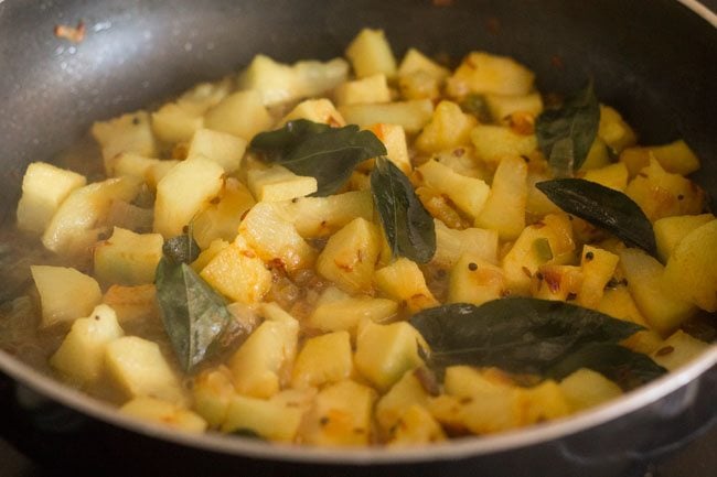 cooking ash gourd thoran in the pan.