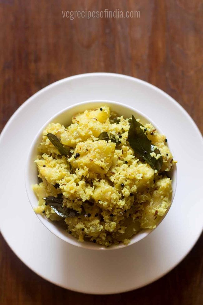 ash gourd thoran served in a white bowl. 