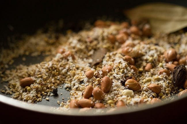 making bagara baingan recipe by toasting the spices and coconut.