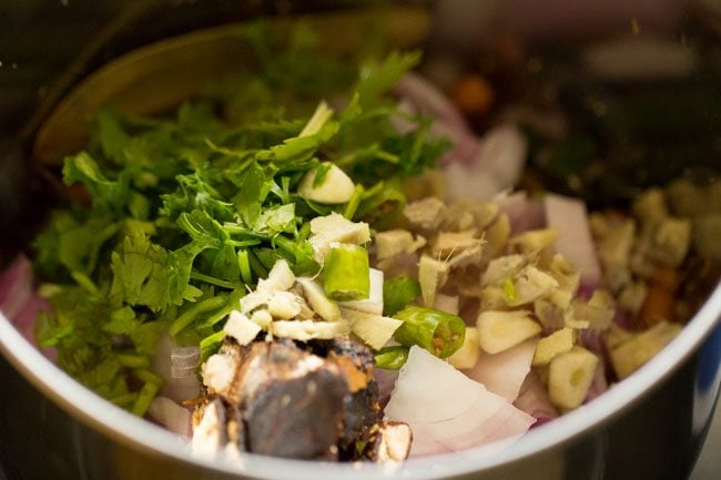 fresh aromatics added to grinder with toasted spices.