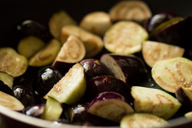 sautéing quartered brinjal for bagara baingan recipe.