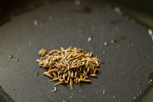 cumin seeds added to pan for tadka.