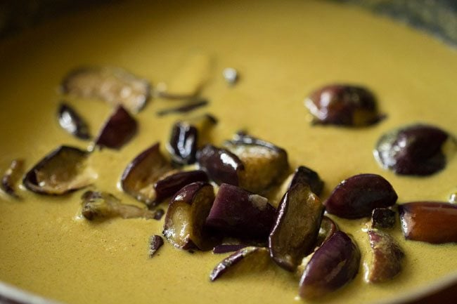 cooked baingan added to bagara gravy to make a brinjal curry for biryani.