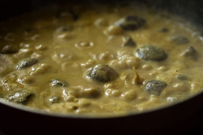 simmering brinjal in curry for bagara baingan recipe.