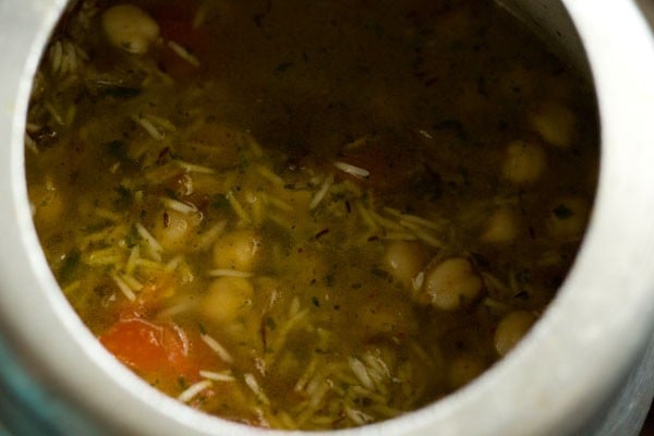 adding water to chickpea rice mixture