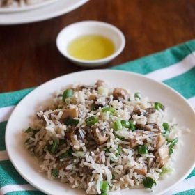 mushroom rice served on a white plate.