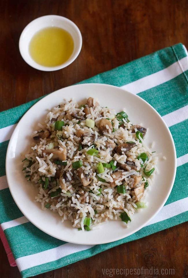 mushroom rice served in a white plate