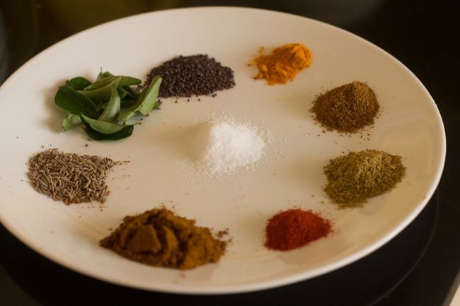 ground spices arranged in a white plate