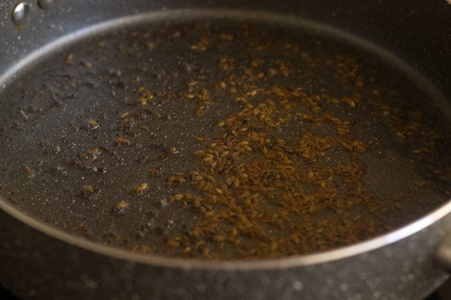sauteing cumin seeds for some seconds in the pan