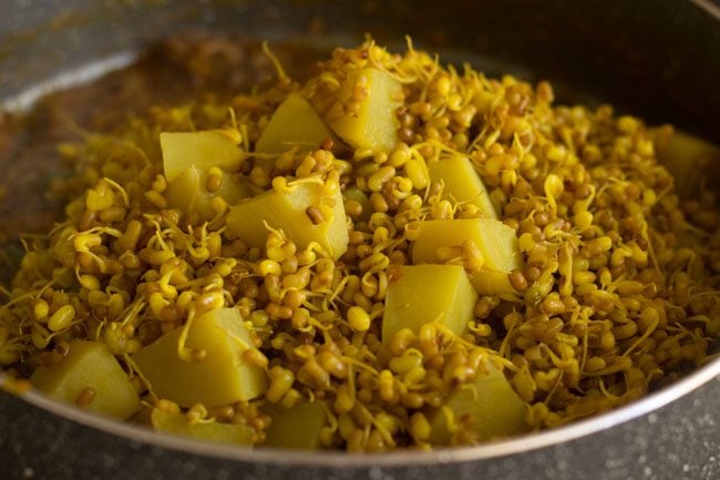 cooked sprouts and water added to pan with tamarind pulp and spices mixture