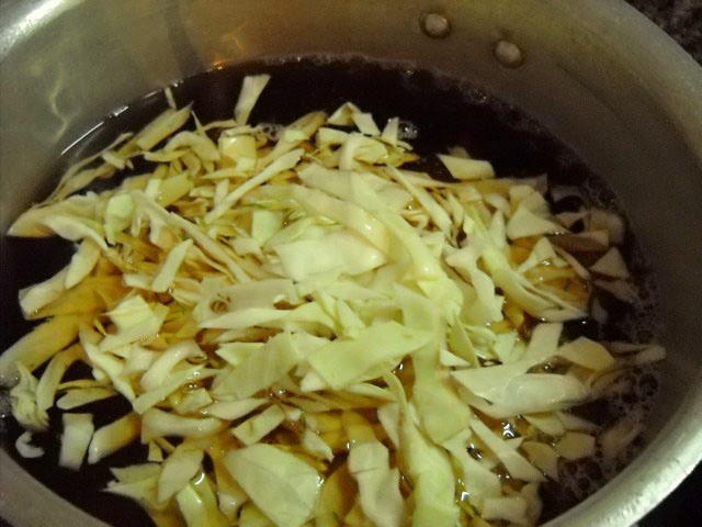 adding cabbage to make borscht soup recipe