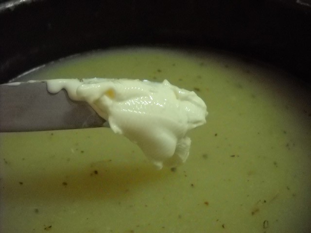 adding cream cheese to soup