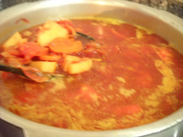 adding-sauted-carrots-beetroot-to-broth preparing veg borscht soup recipe