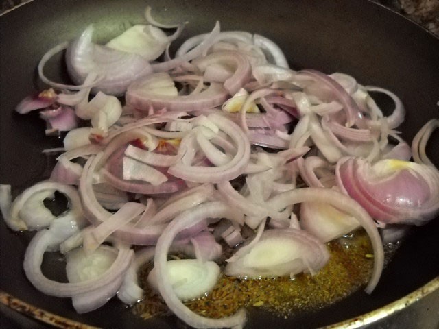 adding sliced onions to make borscht soup recipe