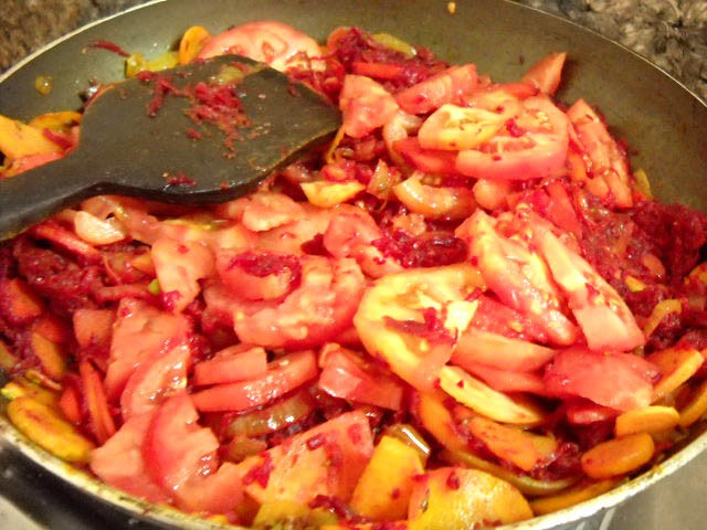 adding-tomatoes-and-grated-beetroot veggies to prepare borscht soup recipe