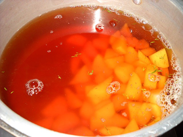 chopped potatoes-added-to-beetroot broth chopped potatoes to make borscht soup recipe