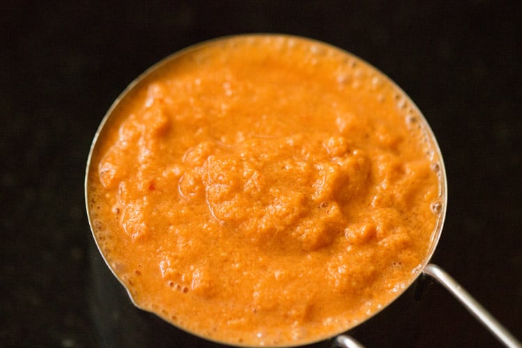 tomato coconut masala paste in a measuring cup