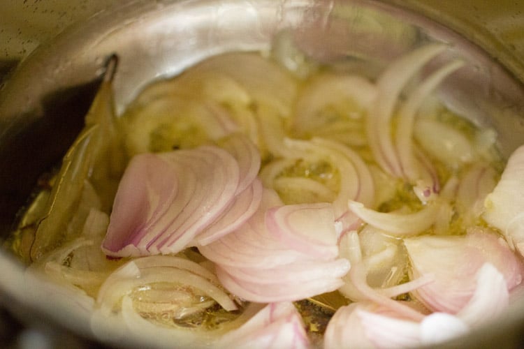 sliced onions added to pan