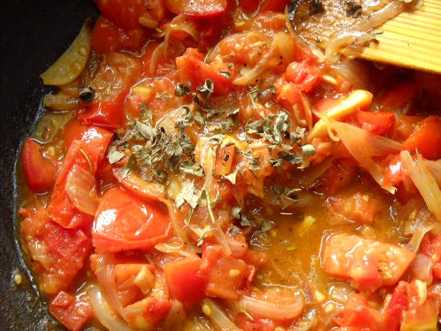adding oregano for tomato mushroom penne pasta recipe