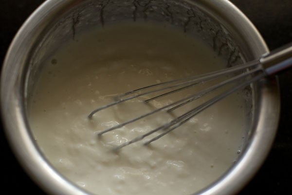 curd being whisked for cucumber raita recipe