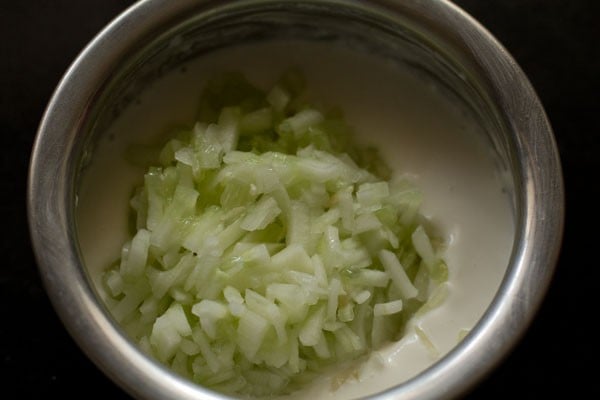 finely chopped cucumber added to whisked curd