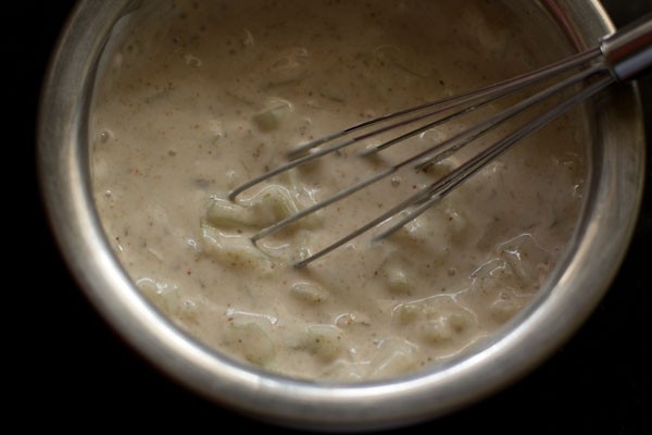 ground spices, salt and cucumber mixed evenly with curd