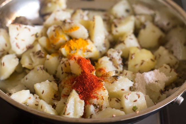 turmeric powder, red chilli powder and salt added to make jeera aloo recipe