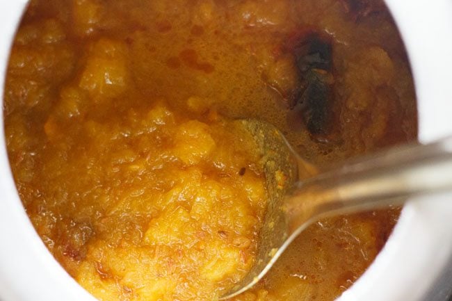 mashing pumpkin with a spoon