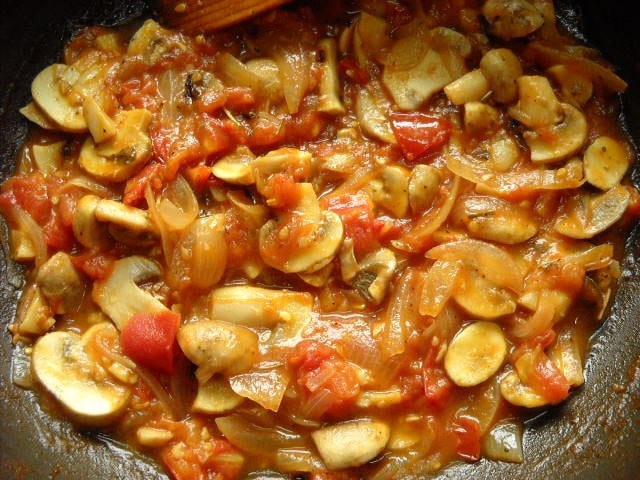 cooking mushrooms in the tomato sauce. 