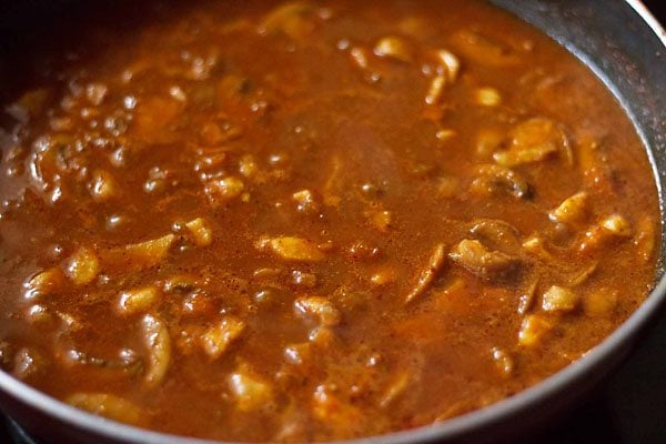 simmering mushroom vindaloo with potatoes. 