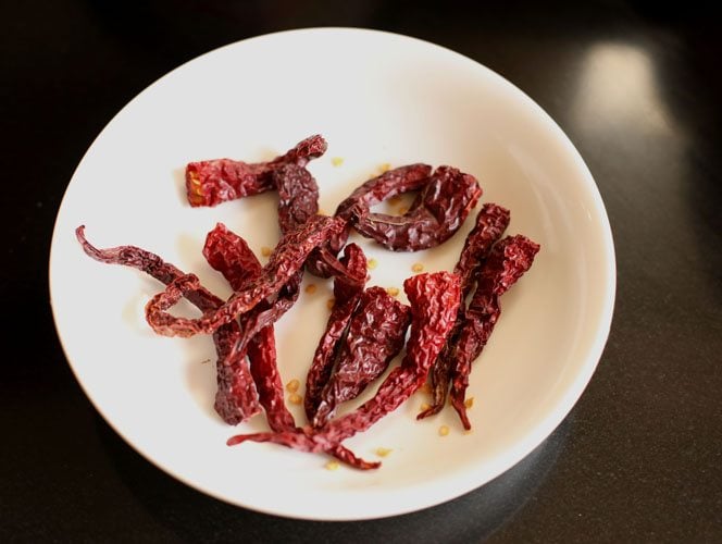 dried kashmiri chilis on a plate.