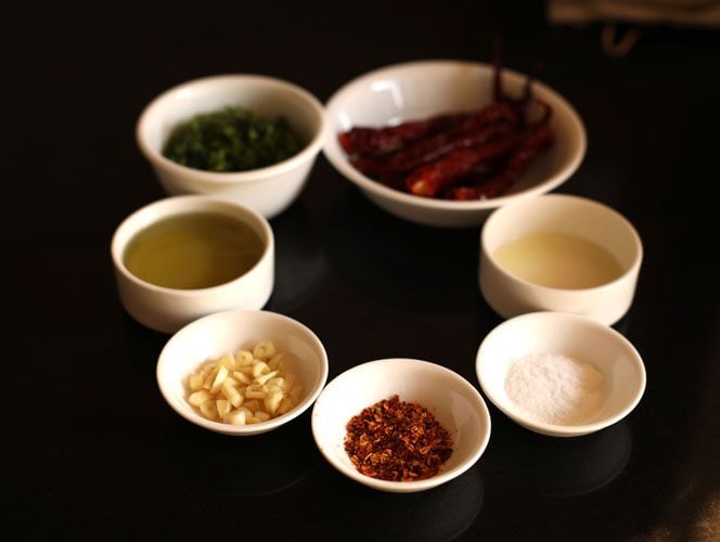 piri piri sauce ingredients measured out into small bowls on a black table.