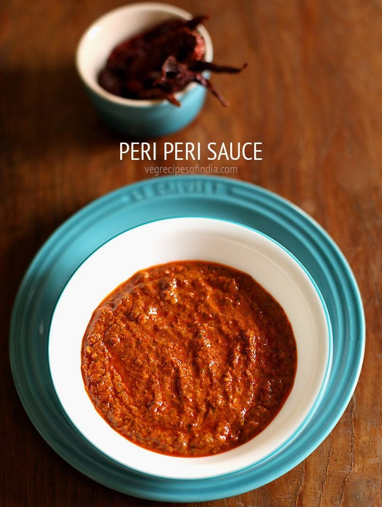 peri peri sauce in a white bowl with a turquoise rim.