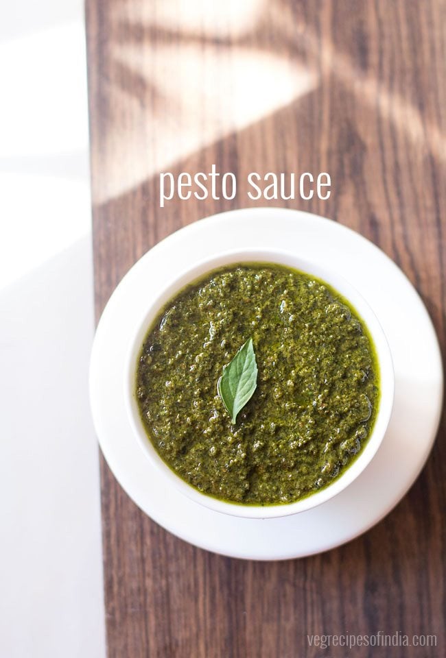 pesto sauce in a white bowl with white text layovers.