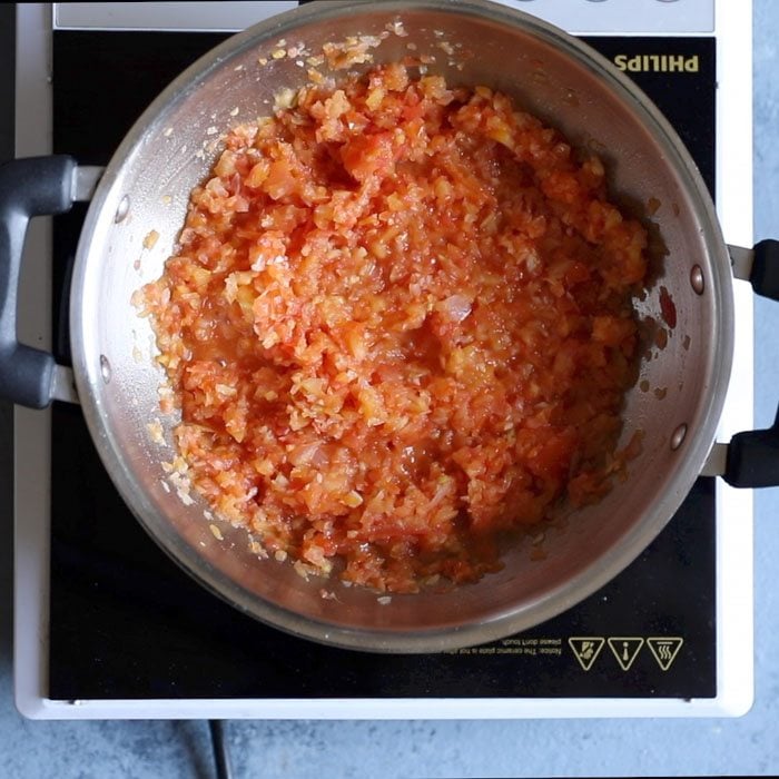 tomatoes being sautéed with aromatics