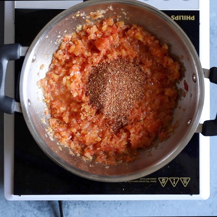 ground kadai masala added to tomatoes