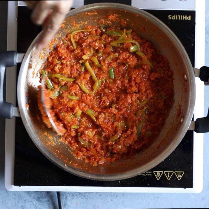 kadai gravy being sautéed with a steep spoon