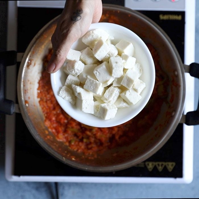 paneer cubes in a white plate to be added to kadai masala