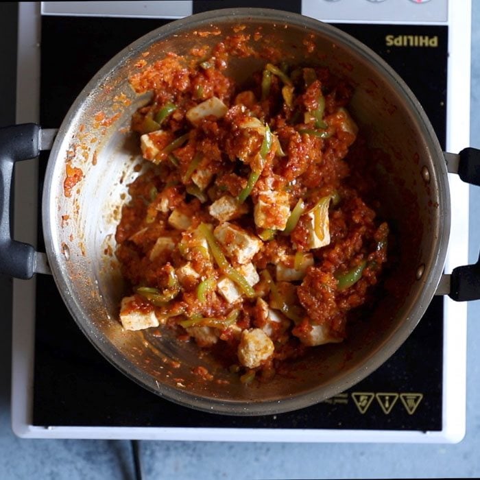 paneer cubes evenly mixed with dry curry sauce