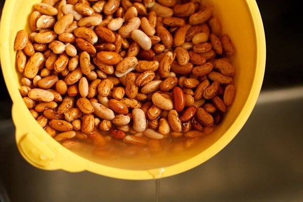 water being discarded from soaked kidney beans