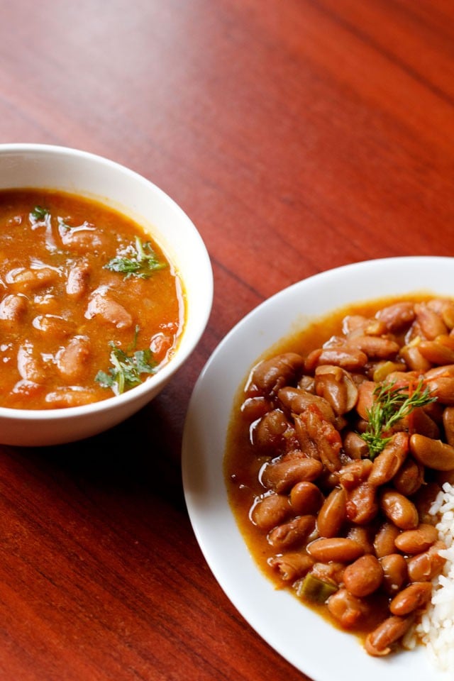 rajma masala in a white plate and filled in a white bowl on a burgundy wooden table